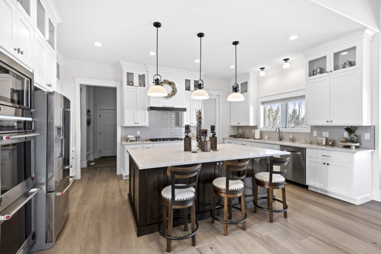 Modern kitchen interior with island and bar stools.