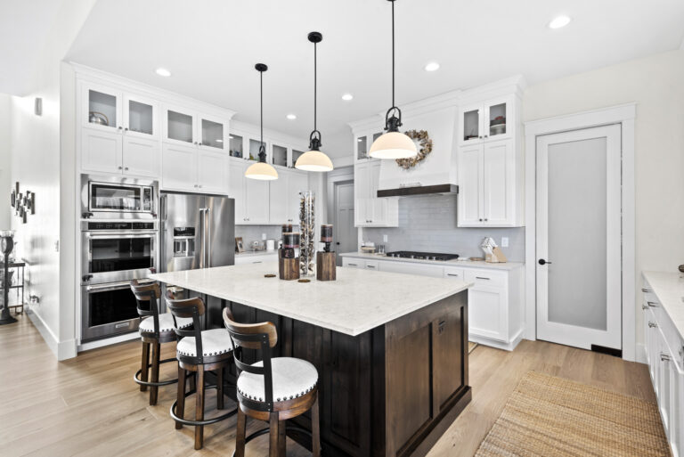 Modern kitchen interior with island and bar stools.