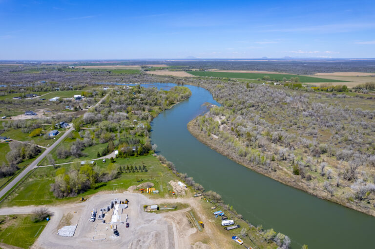 Aerial view of a river with islands and lush greenery surrounding it.