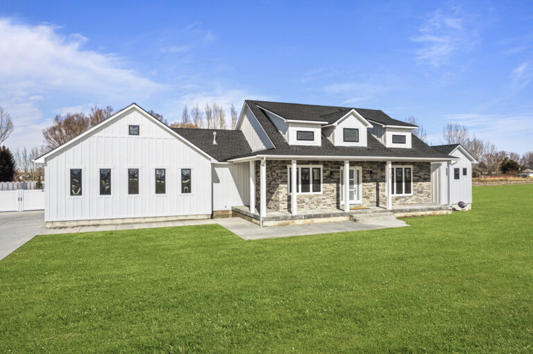 Modern single-story house with a lawn.